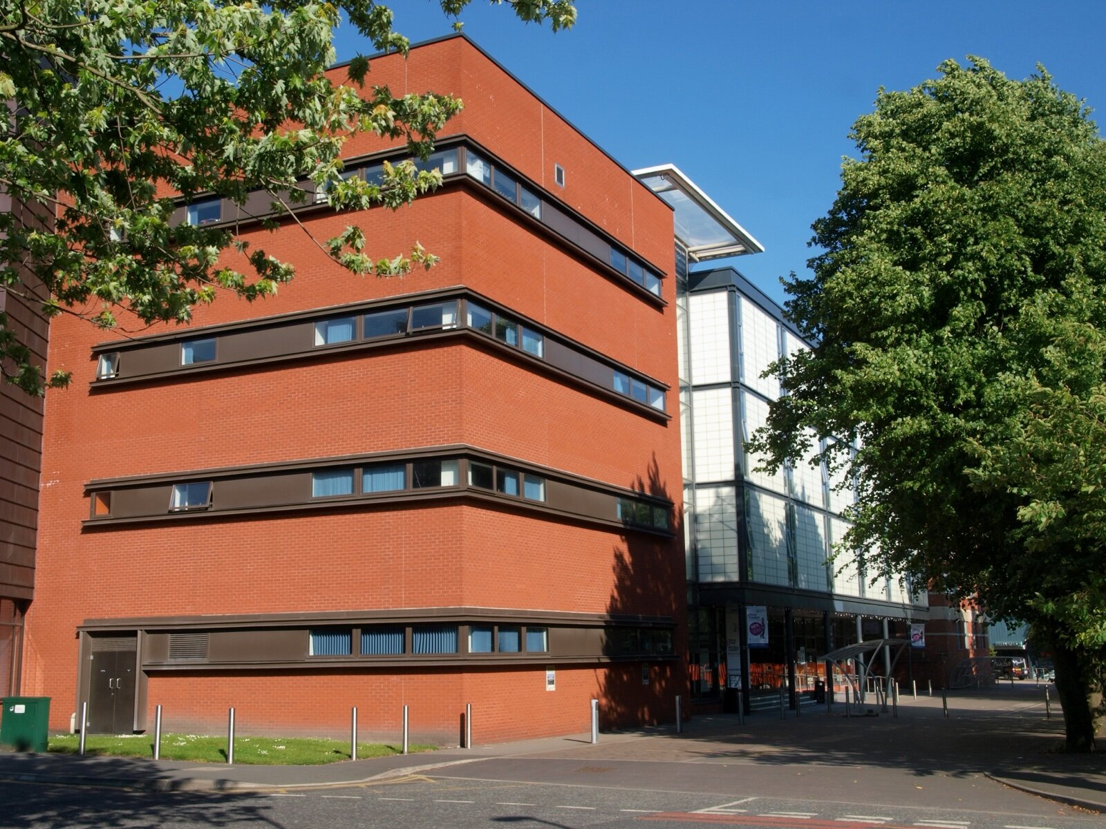 A red-brick sixth-form college building on a sunny day