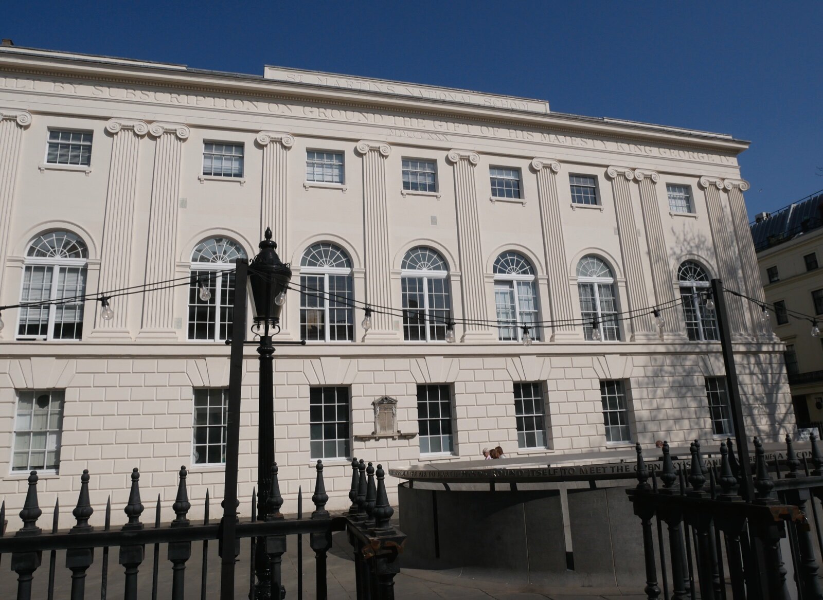 The stuccoed classical facade of the former St Martin's National School building in central London