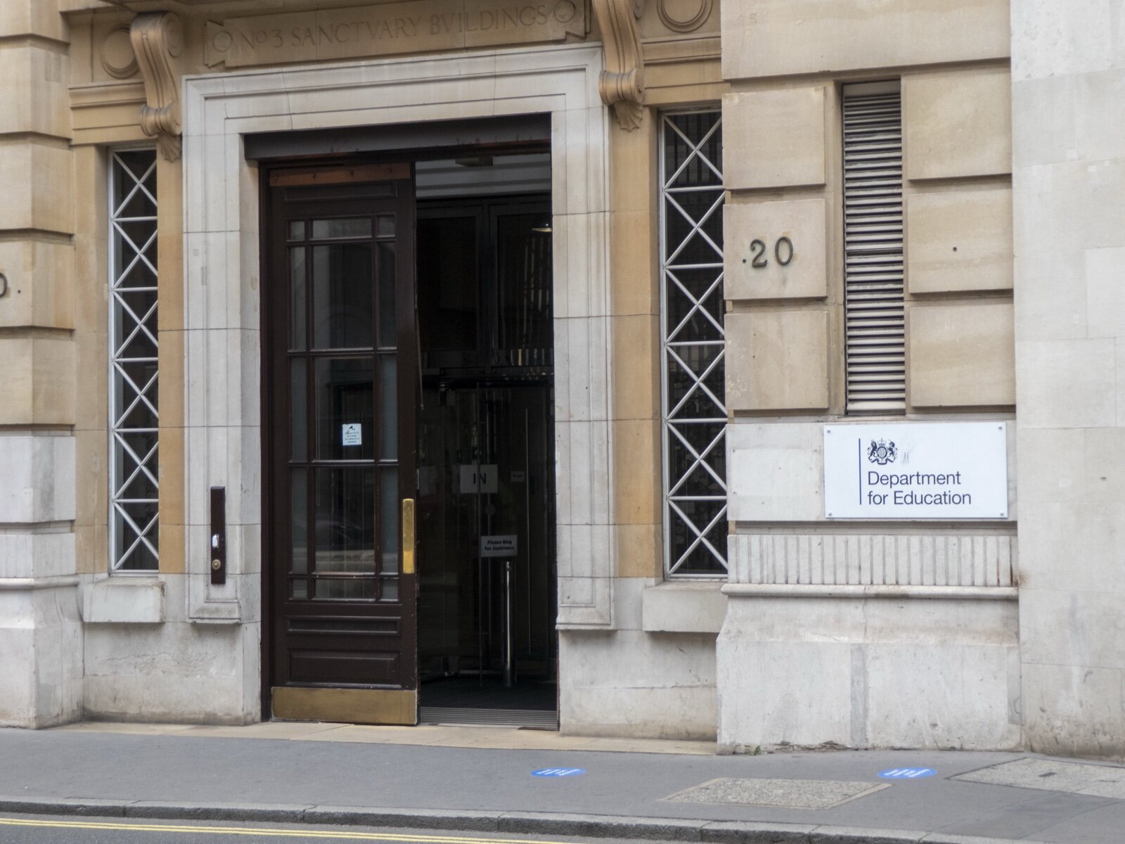 Entrance to No 3 Sanctuary Buildings on Great Smith Street, Westminster, with a Department for Education sign beside the open door
